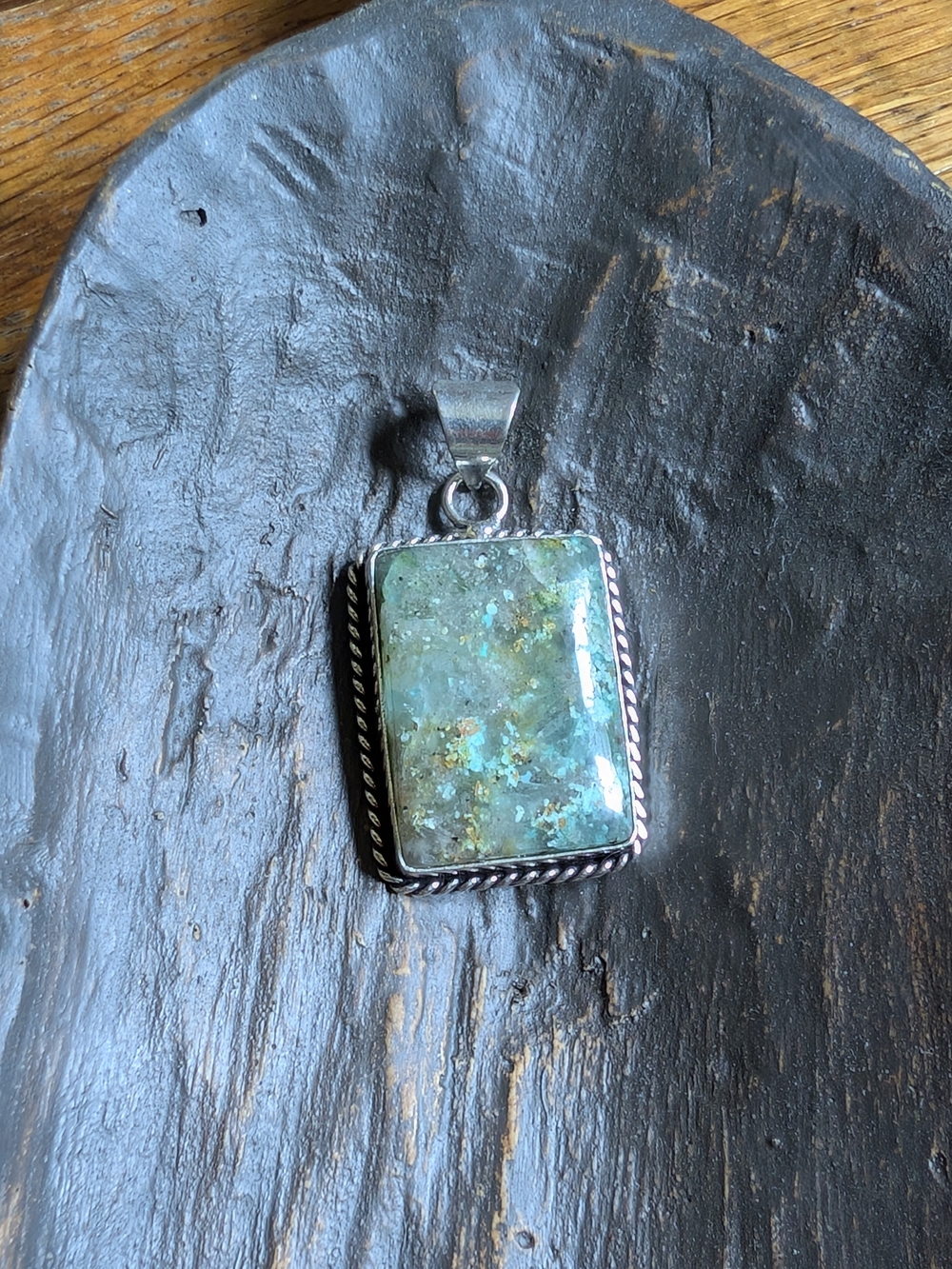 Agate pendant with sterling silver accents and rope detailing. 1.5 inches